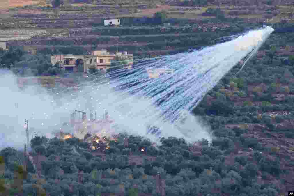A shell from Israeli artillery explodes over a house in al-Bustan, a Lebanese border village with Israel, south Lebanon.&nbsp;Hamas Palestinian militants in southern Lebanon fired 20 rockets into the northern Israeli towns of Schlomi and Nahariyya, the group said in a statement.