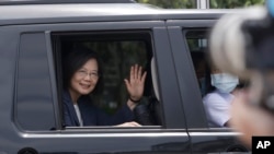FILE - Taiwanese President Tsai Ing-wen waves to the press as she leaves an event at Kaohsiung harbor in Kaohsiung, southern Taiwan, June 10, 2023.