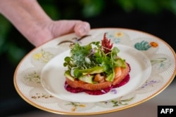 The first course dish of salmon, avocado, red grapefruit, watermelon radish, and cucumber shisho leaf fritters is displayed during an April 9, 2024, preview of a state dinner for Japan's Prime Minister Fumio Kishida and his spouse in Washington.