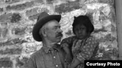 This 1917 photo shows John A. Keirn and an unidentified Hopi child standing outside of the Moencopi Day School on the Hopi Reservation in Arizona. Courtesy of USU Special Collections, Merrill-Cazier Library.