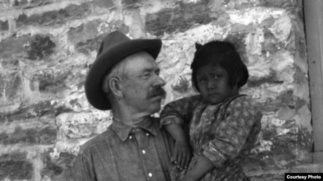 This 1917 photo shows John A. Keirn and an unidentified Hopi child standing outside of the Moencopi Day School on the Hopi Reservation in Arizona. Courtesy of USU Special Collections, Merrill-Cazier Library.