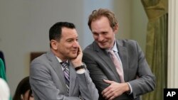 FILE- Former California Assembly Speaker Anthony Rendon, left, and Assembly Republican Leader James Gallagher talk during the session at the Capitol in Sacramento, Calif., Aug. 31, 2022.