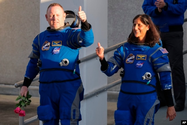 NASA astronauts Butch Wilmore, left, and Suni Williams leave the Operations and Checkout building before heading to the launch complex at the Cape Canaveral Space Force Station, Monday, May 6, 2024, in Cape Canaveral, Fla. (AP Photo/John Raoux)