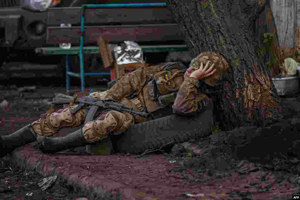 A Ukrainian serviceman rests near the town of Bakhmut, in the Donetsk region, amid the Russian invasion on Ukraine.