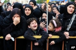 Mourners react during the funeral procession of a Hezbollah fighter and other two civilians who were killed by an Israeli airstrike that hit their house Tuesday night, in Bint Jbeil, South Lebanon, Dec. 27, 2023.