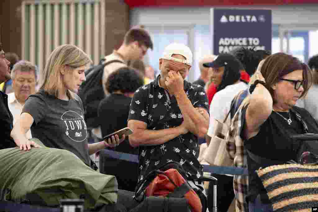 Para penumpang mencoba memesan ulang penerbangan mereka saat berada di Bandara Internasional Hartsfield Jackson di kota Atlanta, AS, karena gangguan internet besar-besaran mengganggu penerbangan, bank, outlet media, dan perusahaan di seluruh dunia. (AP)&nbsp;