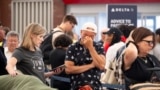 Passengers try to rebook their flights while at Hartsfield Jackson International Airport in Atlanta, as a major internet outage disrupts flights, banks, media outlets and companies across the world. 