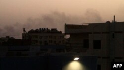 Smoke billows behind buildings in southern Khartoum, on May 27, 2023, amid ongoing fighting between the forces of two rival generals.