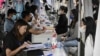 FILE - The photo taken on Aug. 26, 2022, shows young people attending a job fair in Beijing.