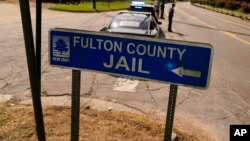 A Fulton County Jail signs points to where the jail is located, Aug. 24, 2023, in Atlanta. 