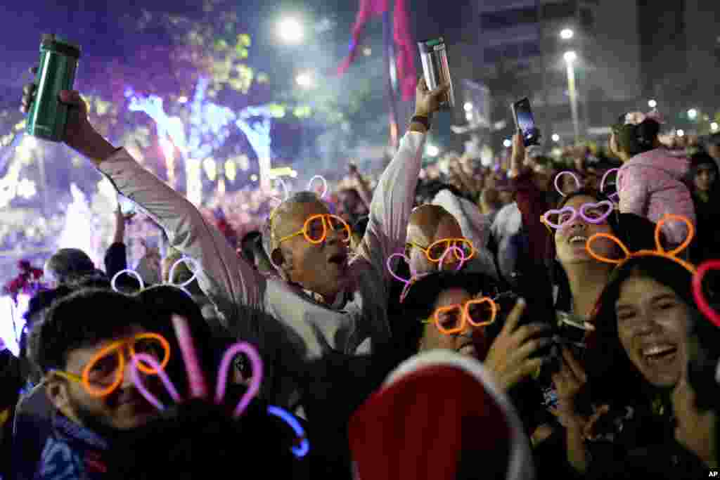 People celebrate New Year at Plaza Altamira in Caracas, Venezuela.