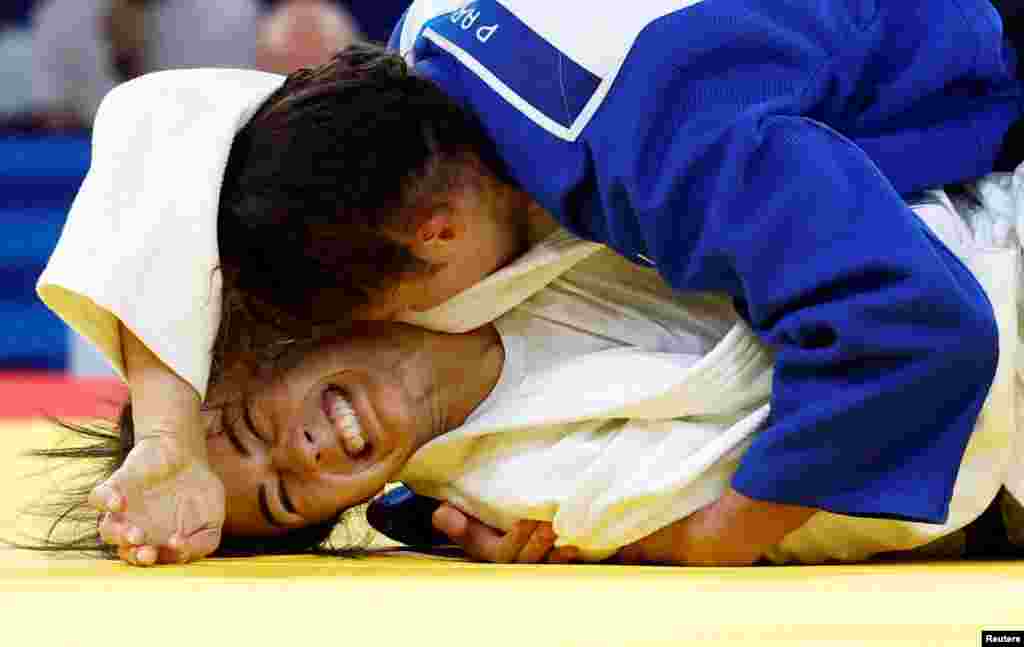 Gabriella Willems of Belgium, left, and Miriam Butkereit of Germany compete during the women-70 kg quarterfinal judo match at Champ-de-Mars Arena during the 2024 Summer Olympics in Paris, France.