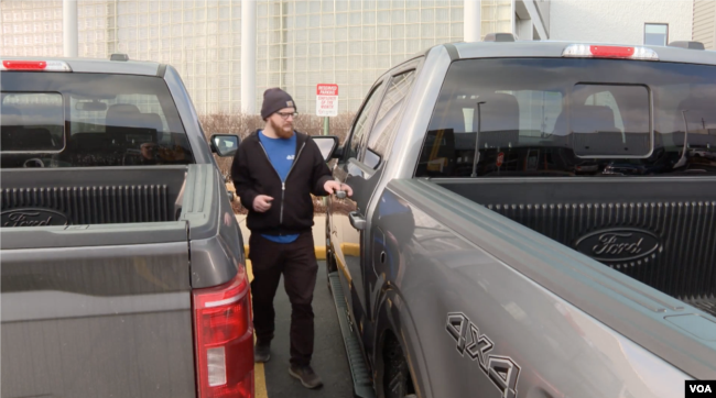 Michigan resident Vaux Adams prepares to drive off with his newly leased Ford F-150 truck in Sterling Heights, Michigan, February 28, 2024. (VOA)