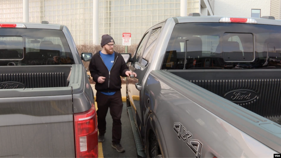 Michigan resident Vaux Adams prepares to drive off with his newly leased Ford F-150 truck in Sterling Heights, Michigan, February 28, 2024.