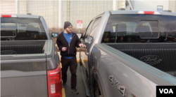 Michigan resident Vaux Adams prepares to drive off with his newly leased Ford F-150 truck in Sterling Heights, Michigan, February 28, 2024.