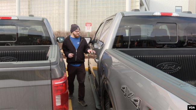 Michigan resident Vaux Adams prepares to drive off with his newly leased Ford F-150 truck in Sterling Heights, Michigan, February 28, 2024.