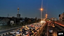 FILE - Cars wait in traffic on a highway with a view of the Milad Tower in Tehran, March 12, 2023. Highway deaths that occur over the Persian new year holiday have been blamed on poor roads, careless driving and poor vehicle quality. 