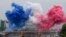 Ceremonial smoke in the colors of the France flag appear over the Seine River in Paris, during the opening ceremony of the 2024 Summer Olympics, July 26, 2024.