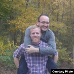 Michael Terry of Atlanta, front, pictured with his husband, Kawika Terry, says the lack of gay acquaintances, media figures or role models when he was growing up in Texas "made me feel like something was wrong with me."