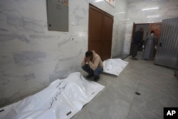 A Palestinian mourns relatives killed in the Israeli bombardment of the Gaza Strip in Khan Younis, Dec. 26, 2023.