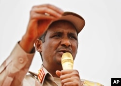 FILE - Gen. Mohammed Hamdan Dagalo speaks during a rally in Mayo district, south of Khartoum, Sudan, June 29, 2019.