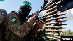 A Hamas fighter takes part in a military parade to mark the anniversary of the 2014 war with Israel, near the border in the central Gaza Strip, July 19, 2023.