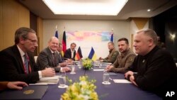 In this photo provided by the Ukrainian Presidential Press Office, Germany's Chancellor Olaf Scholz, second left, and Ukrainian President Volodymyr Zelenskyy, second right, meet during the G-7 Summit in Hiroshima, Japan, May 20, 2023. (Ukrainian Presidential Press Office/AP)