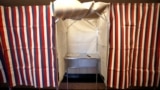 FILE - A booth is ready for a voter at City Hall in Cambridge, Massachusetts, Feb. 24, 2020. Russia-linked online accounts are disseminating divisive content aimed at influencing the upcoming U.S. presidential election, Microsoft said on April 17, 2024.