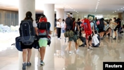 Participants who left the camping site of the 25th World Scout Jamboree, arrive at a university in Incheon, South Korea, Aug. 8, 2023.