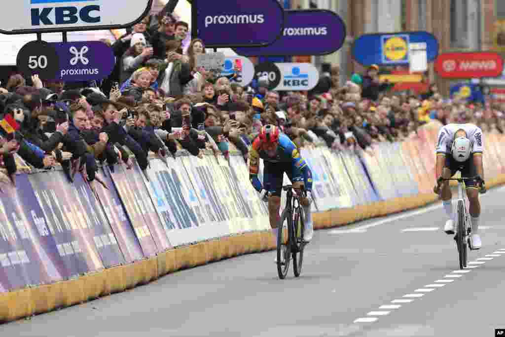 Denmark&#39;s Mads Pedersen of the LIDL-Trek team, left, sprints toward the finish line ahead of Netherland&#39;s Mathieu Van Der Poel of the Alpecin-Deceuninck team during the Gent Wevelgem cycling race in Wevelgem, Belgium.