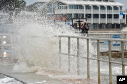 The surf pushed by winds from Tropical Storm Debby breaks over the sea wall in Cedar Key, Florida, Aug. 4, 2024.