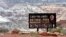 FILE - A sign for Canyonlands National Park is seen in Moab, Utah, May 6, 2003. Three hikers died over the weekend in suspected heat-related incidents at parks in Utah.