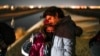 FILE - A couple from Cuba wait to be processed to seek asylum after crossing the border into the United States, Jan. 6, 2023, near Yuma, Ariz.