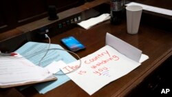 A sign rests on the desk of Rep. Gloria Johnson, D-Knoxville, in the House chamber as proceedings were brought to expel her from the legislature, April 6, 2023, in Nashville, Tenn.