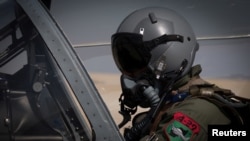 FILE - A U.S.-trained Afghan pilot prepares for take-off in the cockpit of his aircraft, at Kandahar Airfield, Afghanistan, Sept. 10, 2017. Many Afghan pilots were promised eventual resettlement in the U.S. (U.S. Air Force/Staff Sgt. Alexander W. Riedel/Handout via Reuters)