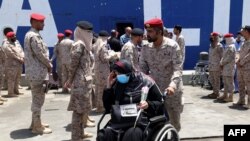 FILE: A woman evacuated from Sudan is wheeled by a Saudi soldier off a ferry which transported some 1900 evacuees across the Red Sea from port Sudan to the Saudi King Faisal navy base in Jeddah, on April 29, 2023, during mass evacuations from Sudan. 