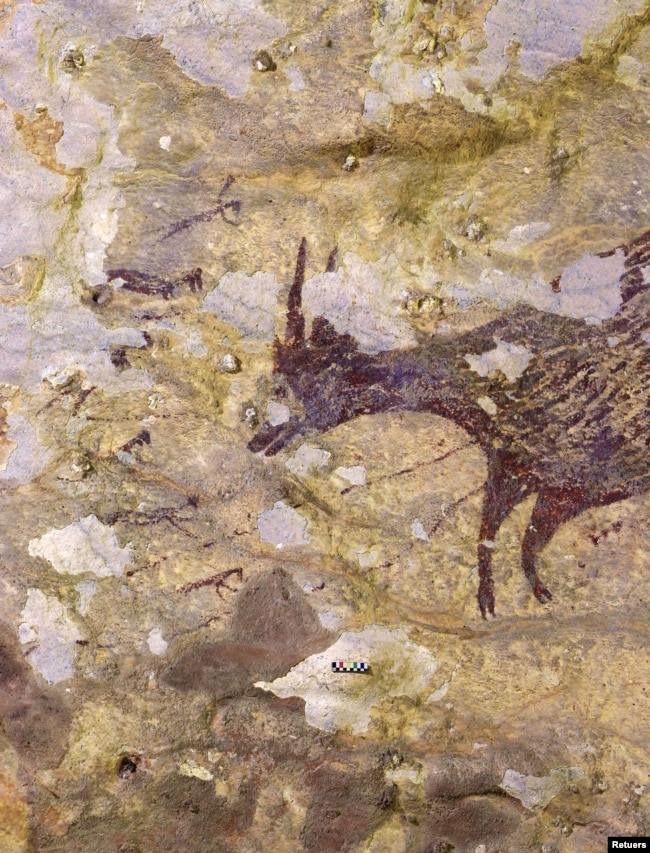 FILE - A cave painting is seen in Leang Bulu' Sipong 4 limestone cave in South Sulawesi, Indonesia December 4, 2019. (Courtesy of Indonesia's National Research Centre for Archaeology/Griffith University/Handout via REUTERS)