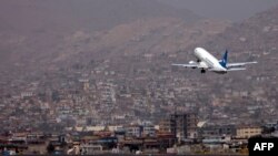 FILE - An Ariana Afghan Airlines aircraft takes off from the airport in Kabul, Sept. 11, 2021.