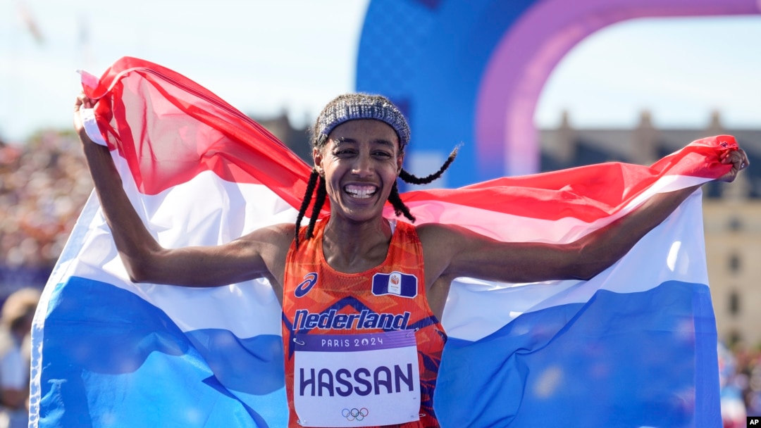 Sifan Hassan, of the Netherlands, celebrates after crossing the finish line to win the gold medal at the end of the women's marathon competition at the 2024 Summer Olympics, Aug. 11, 2024, in Paris. 