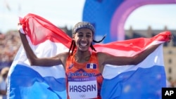 Sifan Hassan, of the Netherlands, celebrates after crossing the finish line to win the gold medal at the end of the women's marathon competition at the 2024 Summer Olympics, Aug. 11, 2024, in Paris. 