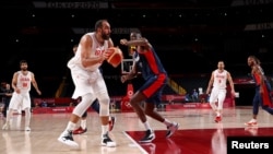 FILE - Hamed Haddadi of Iran, second left, is seen in action with Moustapha Fall of France at the Tokyo Olympics in Saitama, Japan, July 31, 2021.