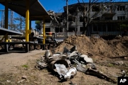 Debris from a Russian missile is gathered next to a damaged building in a DTEK thermal power plant after a Russian attack in Ukraine, May 2, 2024.