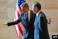 US Secretary of State Antony Blinken, left, gestures to China's Foreign Minister Wang Yi as they meet on the sidelines of the 57th Association of Southeast Asian Nations foreign ministers' meeting in Vientiane, Laos, on July 27, 2024.