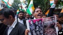 FILE - People protest against recent attacks on Hindus in Bangladesh, in Hyderabad, India, Aug. 14, 2024.