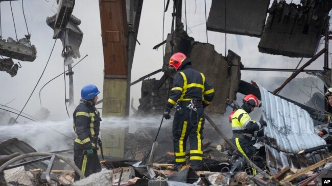 Firefighters put out a fire after a Russian rocket attack in Kyiv, Ukraine, Aug. 30, 2023. Over 20 rockets and drones have been shot down by the air defense system in Kyiv overnight.