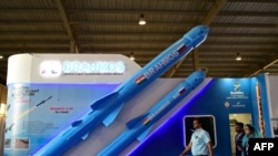 FILE - Visitors walk past a model of India's Brahmos supersonic cruise missile displayed at the Defence Expo 2022 in Gandhinagar on Oct. 18, 2022. 