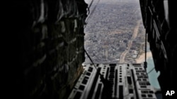 FILE - Containers of humanitarian aid are ready to be dropped from a U.S. C-17 Air Force plane to Palestinians in the Gaza Strip, March 29, 2024. 