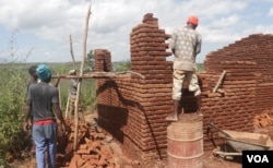Builders construct a low-cost house for a cyclone victim in the Matindi area in Blantyre, Malawi. (Lameck Masina/VOA)