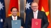 Australian Prime Minister Anthony Albanese and Vietnamese Prime Minister Pham Minh Chinh exchange documents during a signing ceremony at Parliament House in Canberra, Australia, March 7, 2024.