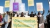 FILE - People hold banners in support of LGBTQ+ rights outside the Namibian high court, which made a landmark ruling in favor of LGBTQ+ communities in Windhoek on June 21, 2024. Advocates say people who identify as LGBTQ+ have difficulty getting health care in Namibia.